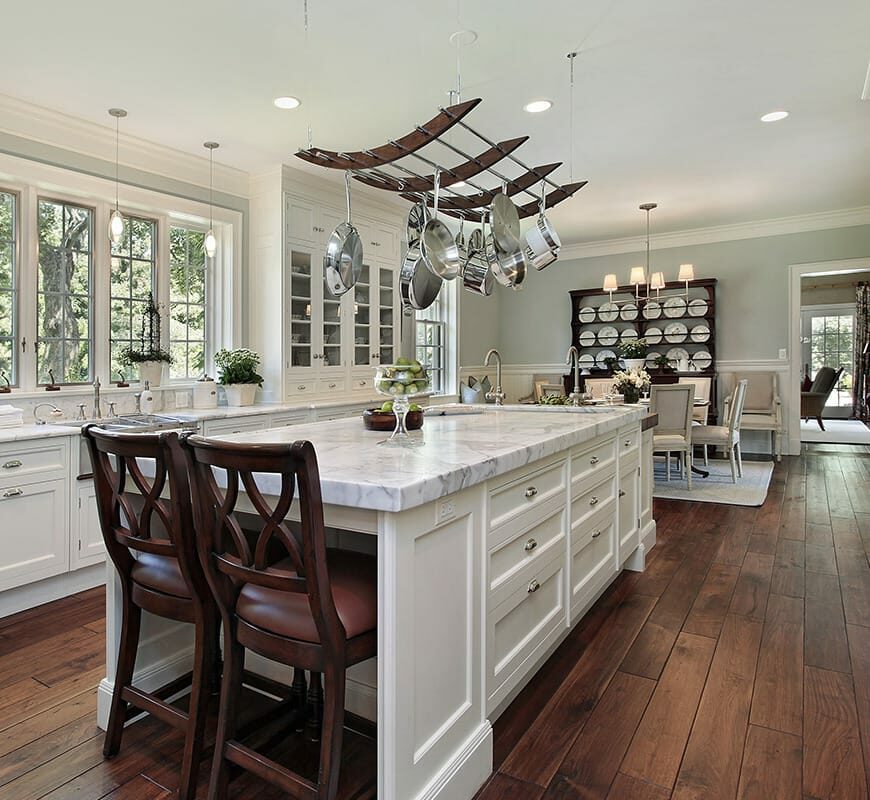 Kitchen- hardwood floors white cabinets and marble counters