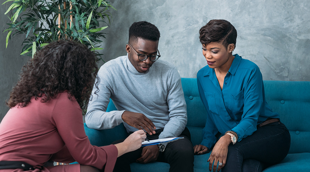 Couple is reviewing documents with an expert