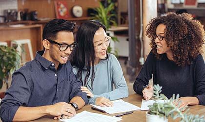 Couple meeting with expert reviewing documents