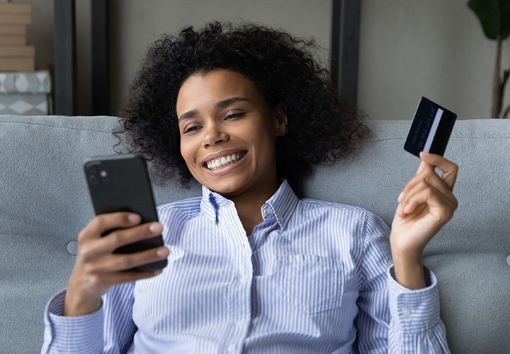 Woman sitting on couch looking at cell phone