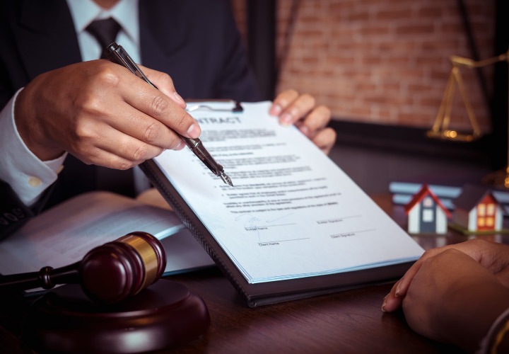 Lawyer showing a contract and pen to someone