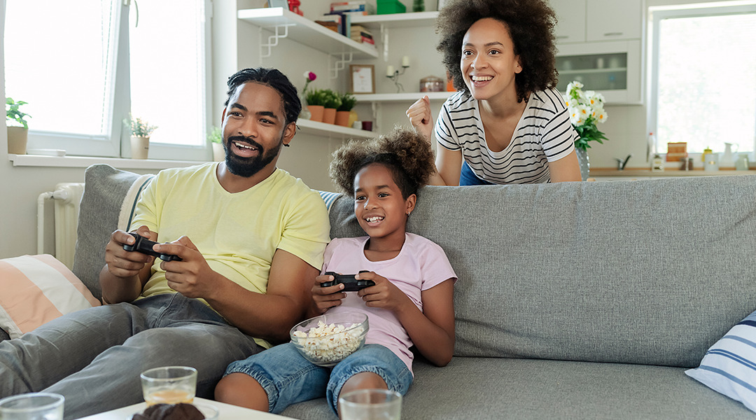 Smiling family playing a video game