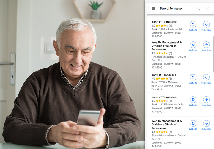 Seated man reading at Bank of Tennessee reviews on phone