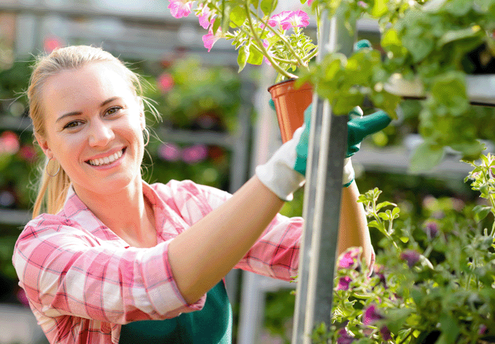 Woman holding a plant in plant store