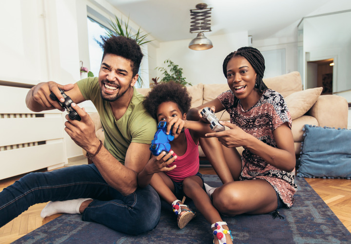 Smiling family playing a video game