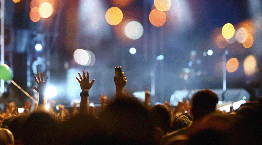 A view from the audience of an out of focus concert stage.