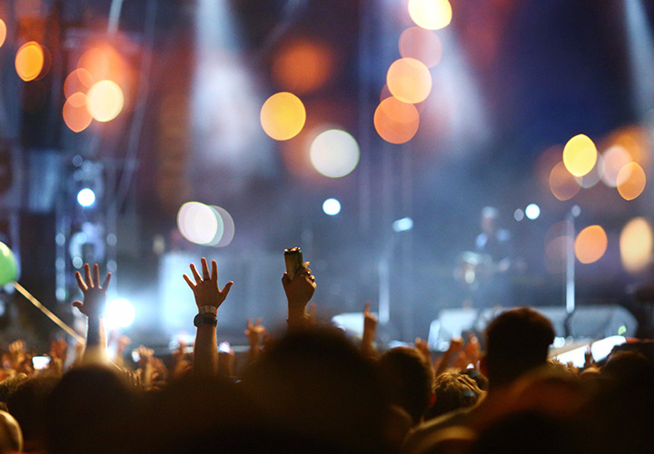 A view from the audience of an out of focus concert stage.