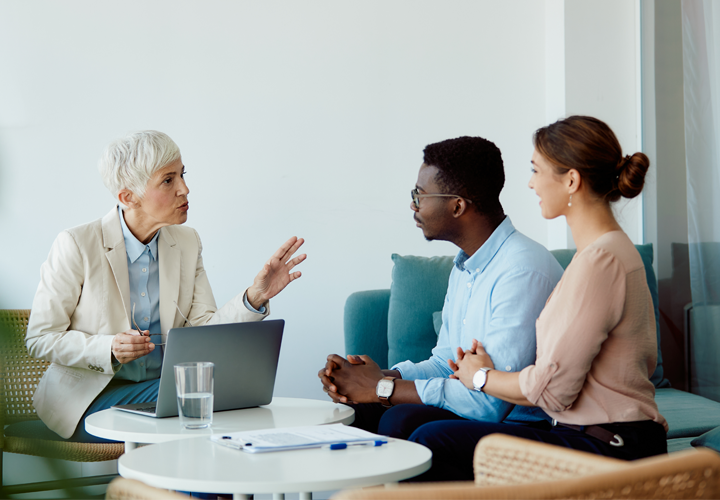 A couple are meeting with a home equity line of credit lender to discuss options.