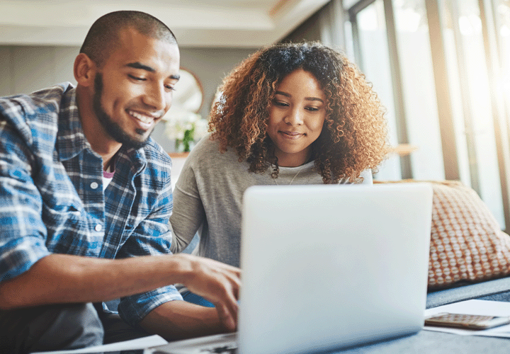 A couple is looking at their laptop checking their online banking account.